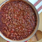 pot of chili with wooden spoon beside