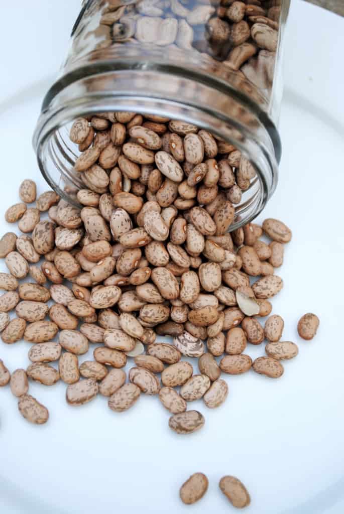 Dry beans spilling out of a jar