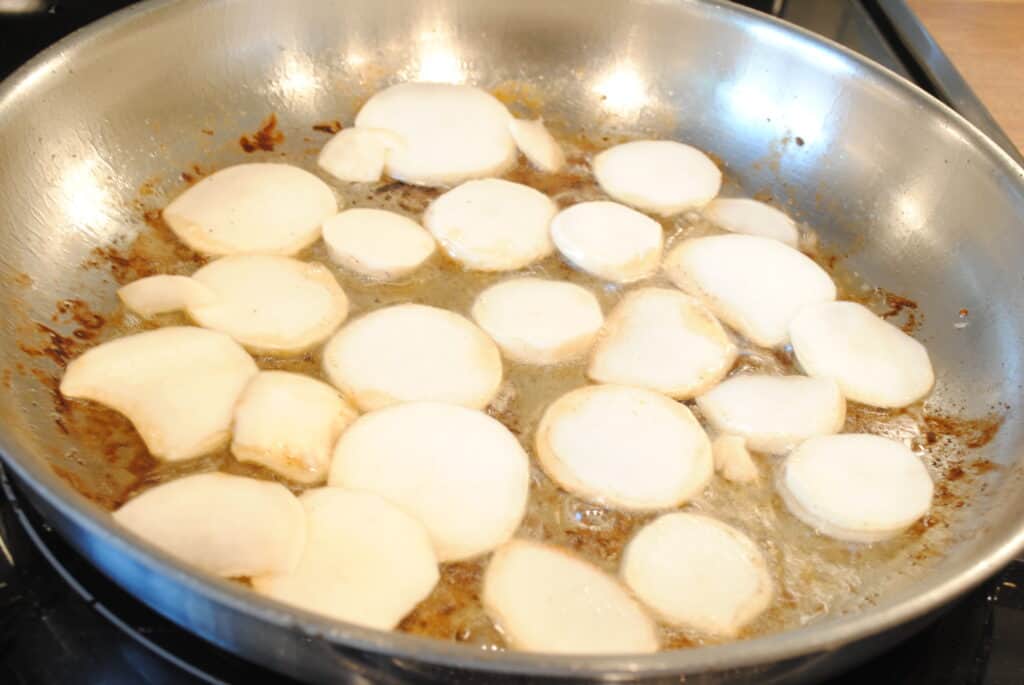 turnip slices cooking in bacon fat