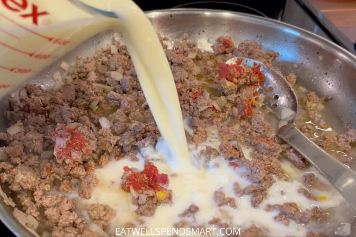 milk pouring into cheeseburger macaroni