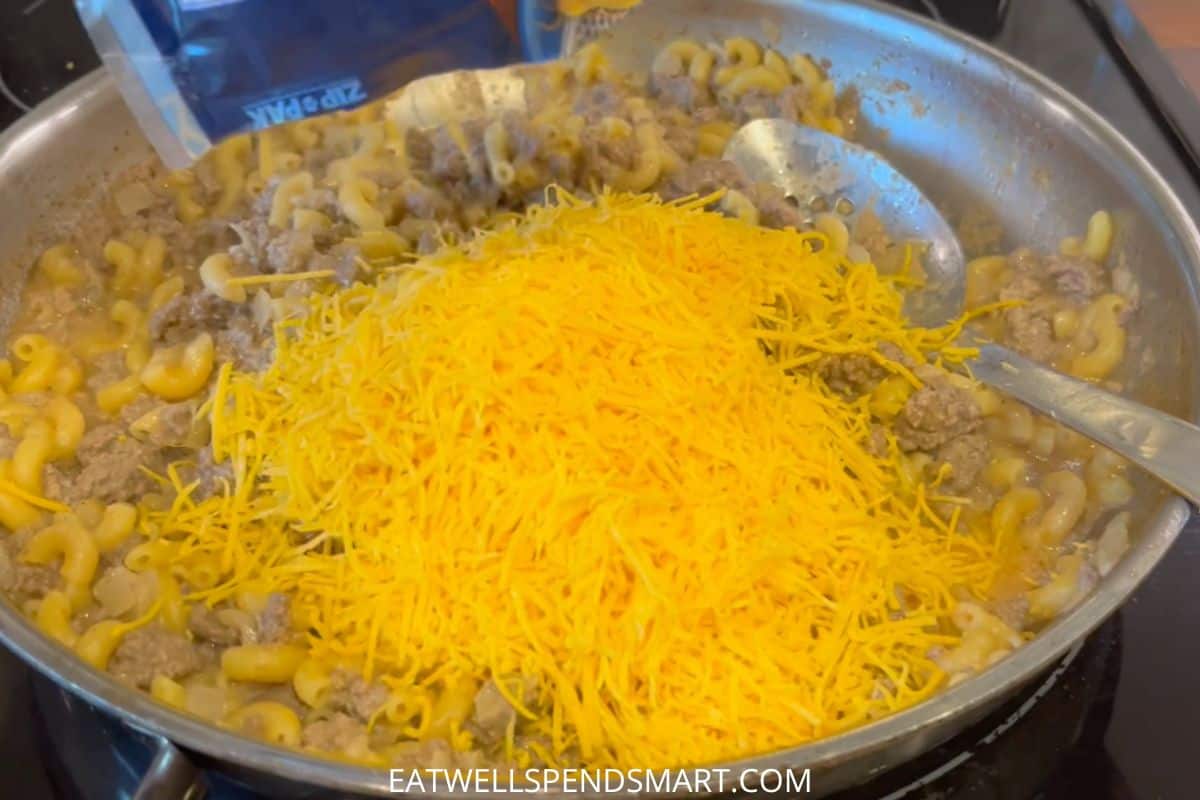 Cheese pouring into cheeseburger macaroni