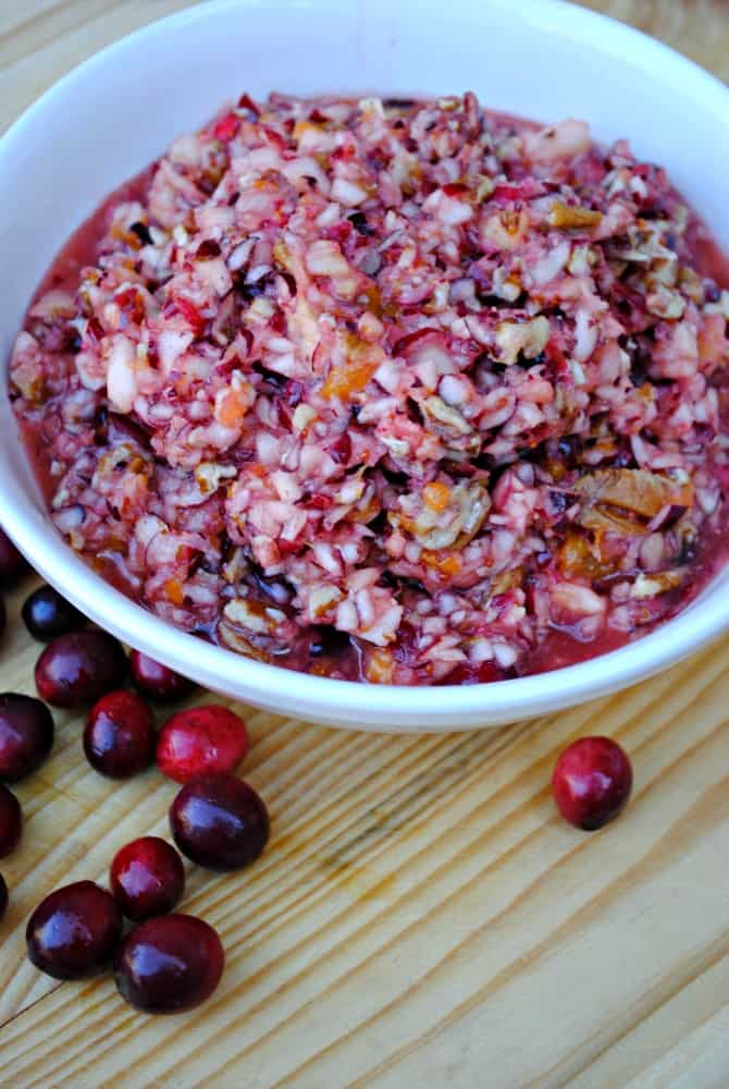 Fresh cranberry salad with finely chopped cranberries, apples, mandarin oranges, pineapple, and pecans