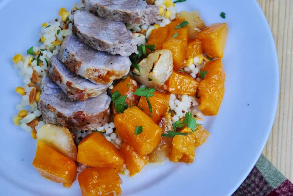 Pork tenderloin, butternut squash and apples on a bed of harvest grain blend