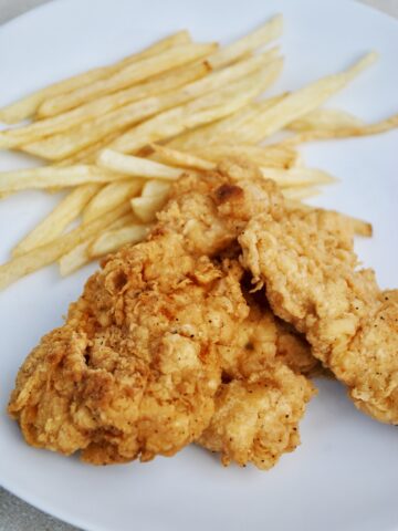 Crispy chicken fingers and fries on a plate
