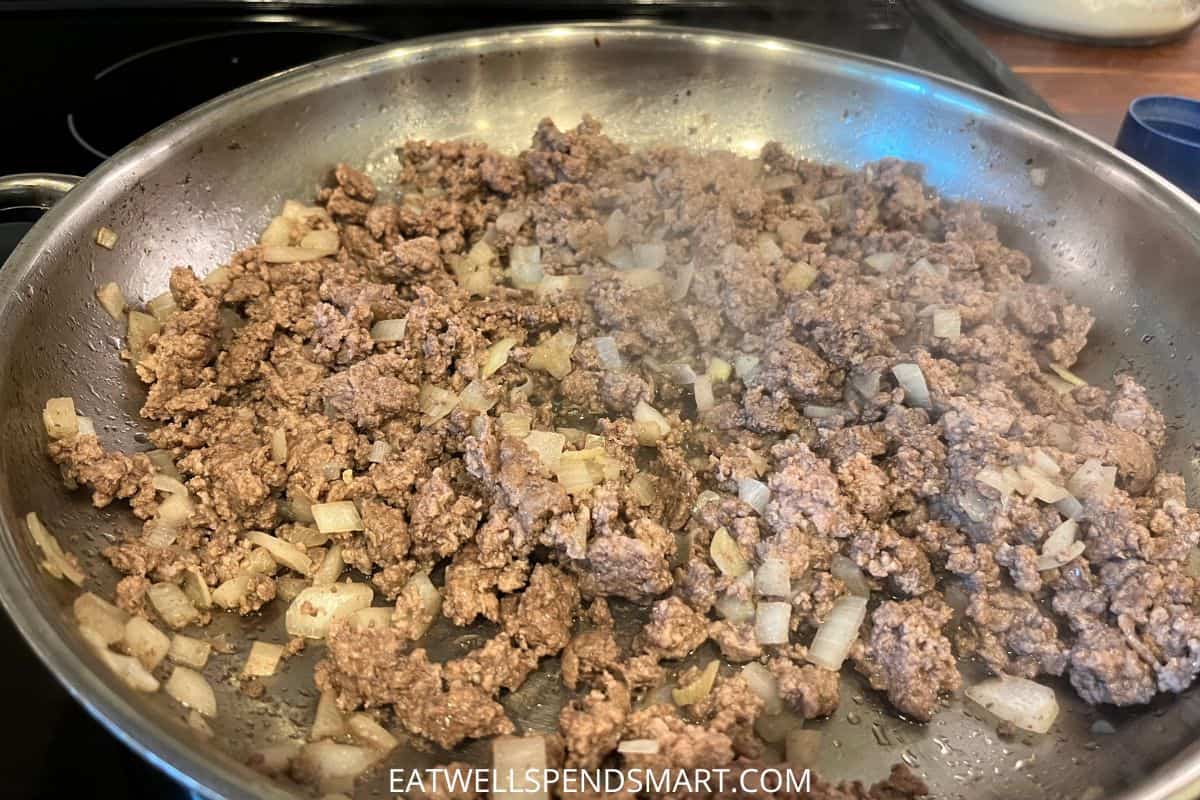 ground beef and onions browning in a skillet