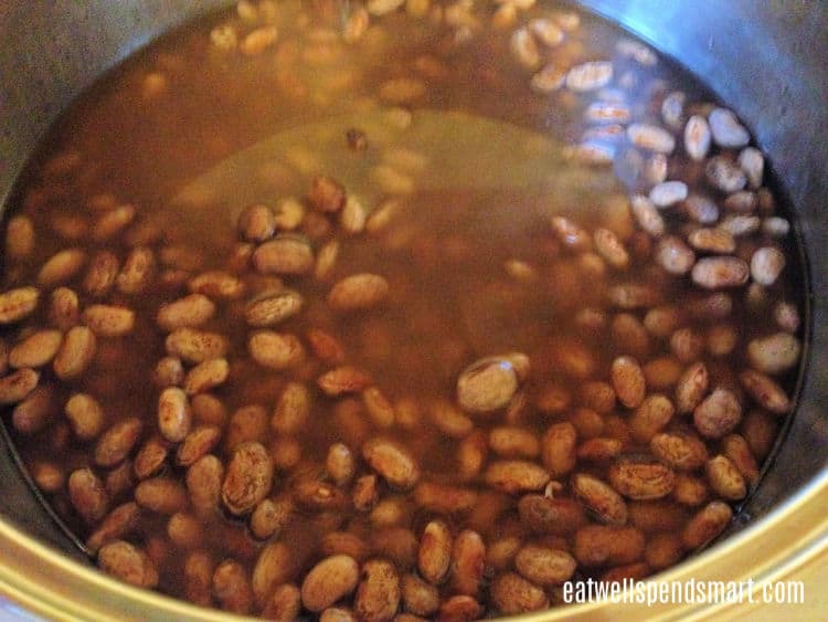 soaked pinto beans in a metal pot
