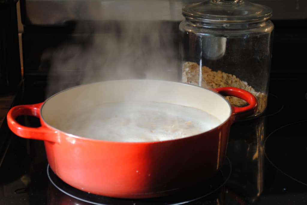 Premium Photo  Closeup of a person making oatmeal with milk in a pot on  the stove