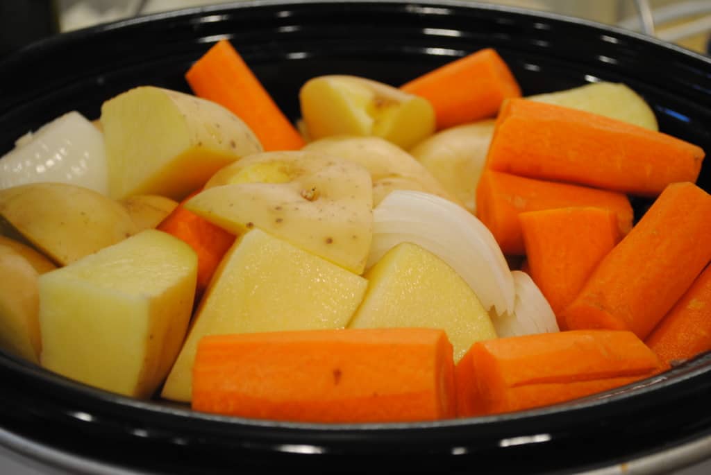 potatoes, carrots, and onions, in a slow cooker
