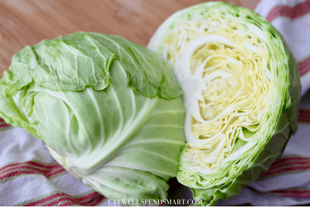 Cabbage cut in half on a striped towel