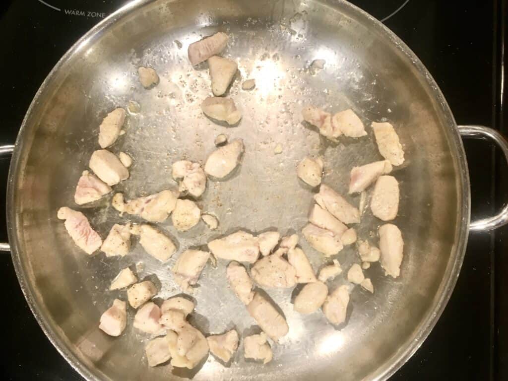 chicken cooking in a skillet