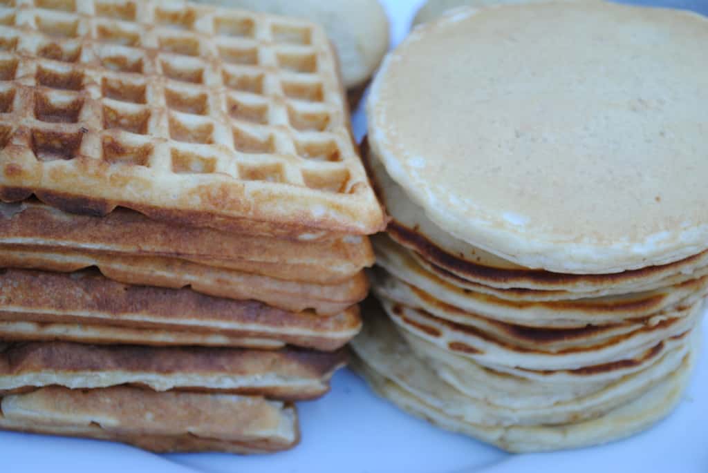 stack of waffles and pancakes on a white plate