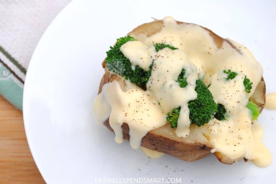 baked potato topped with broccoli and cheese sauce