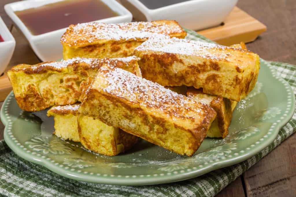 French toast sticks on a green plate