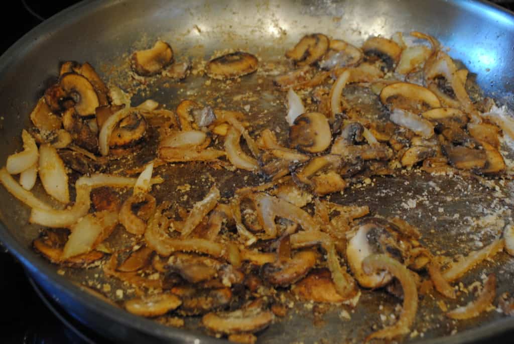 Mushrooms, onions, and flour in a skillet