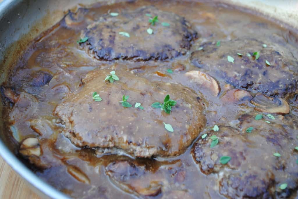 Ground beef patties in an onion and mushroom brown gravy.