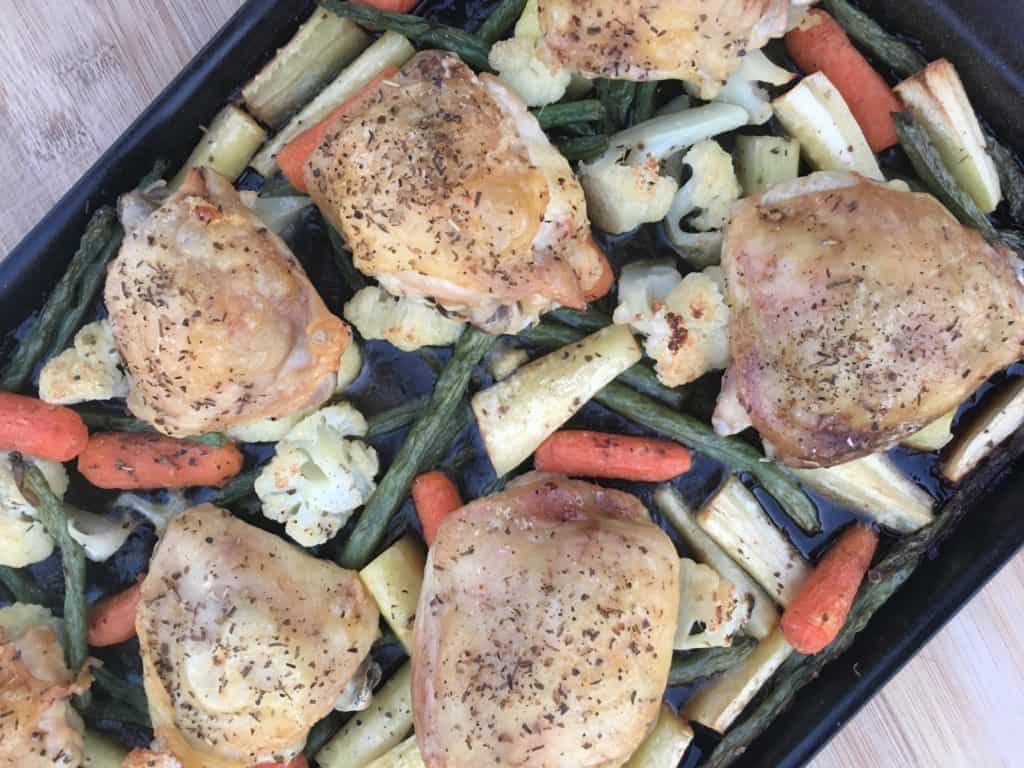 Herb roasted chicken thighs with vegetables on a sheet pan
