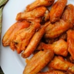 baked buffalo wings on a white plate
