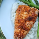 Cajun broiled salmon on a bed of rice with asparagus on the side