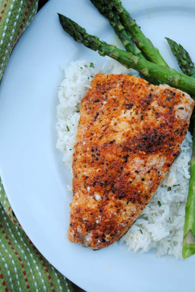 Cajun broiled salmon on a bed of rice with asparagus on the side