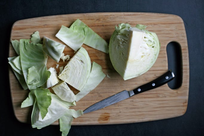 knife and chopped cabbage on cutting board