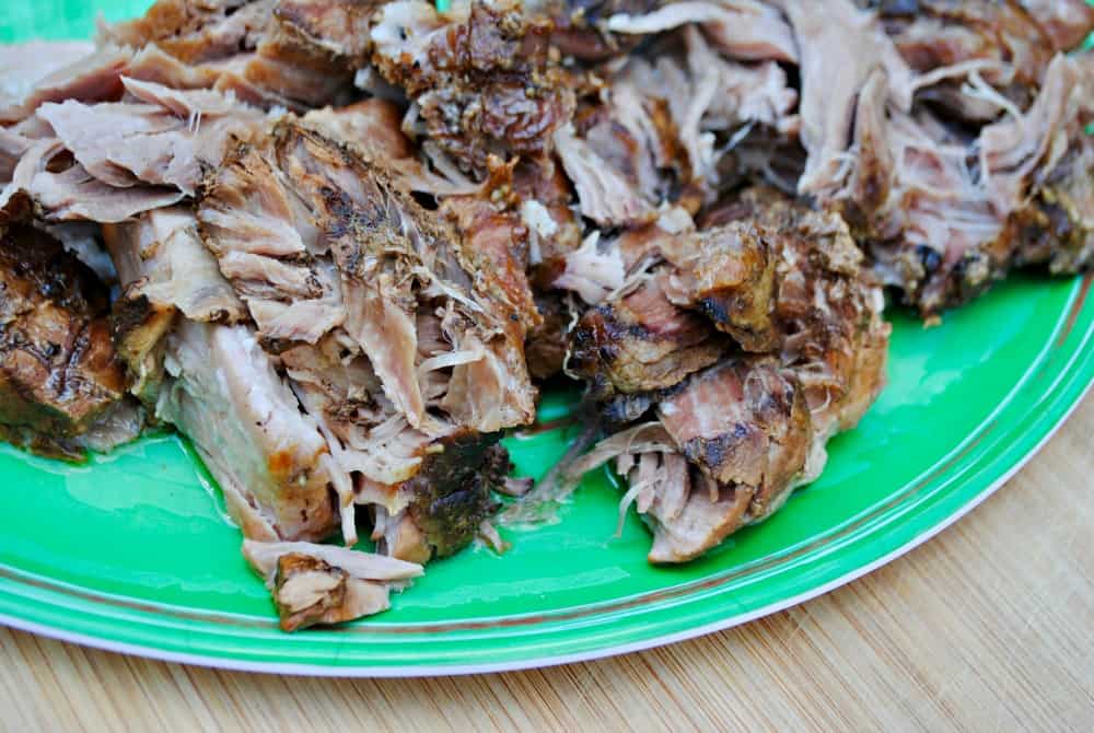 shredded pork roast on green platter