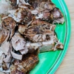 slow cooker pork roast on a green plate