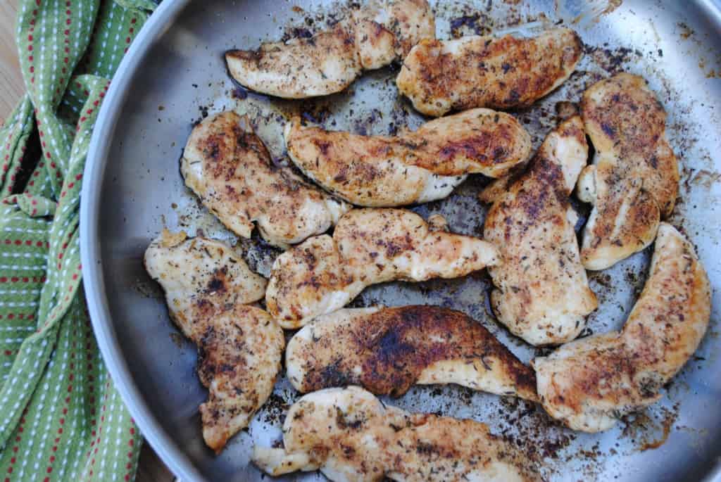 sautéd chicken tenders in a stainless steel skillet