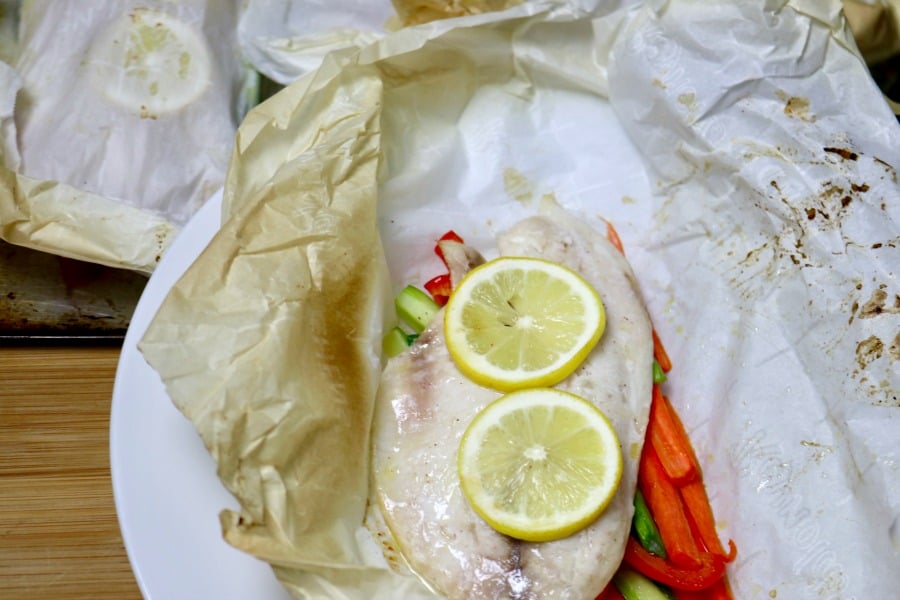 Delicate white fish filet on top of julienned vegetables and baked in a parchment packet.