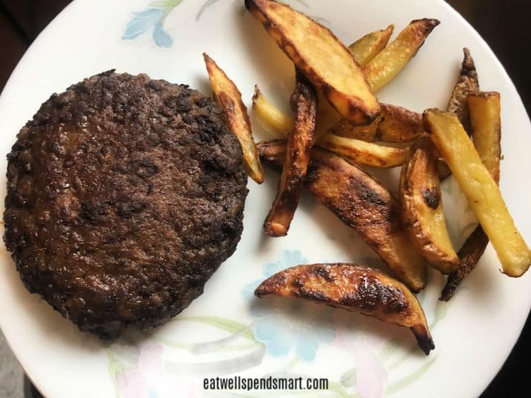 Burger patty and oven fries on a floral plate