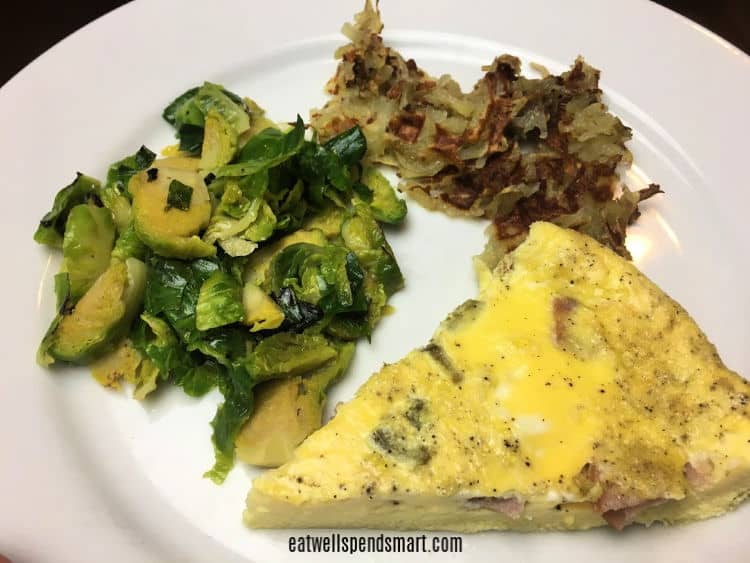 Egg bake, Brussels sprouts, and hashbrowns on a white plate