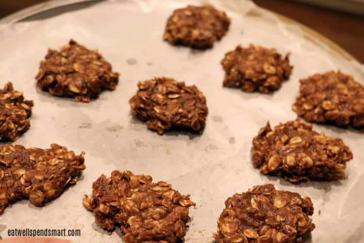 chocolate oat no-bake cookies on a parchment lined sheet pan