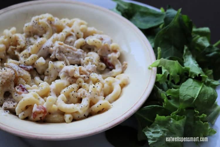 bowl of chicken bacon pasta with a side salad