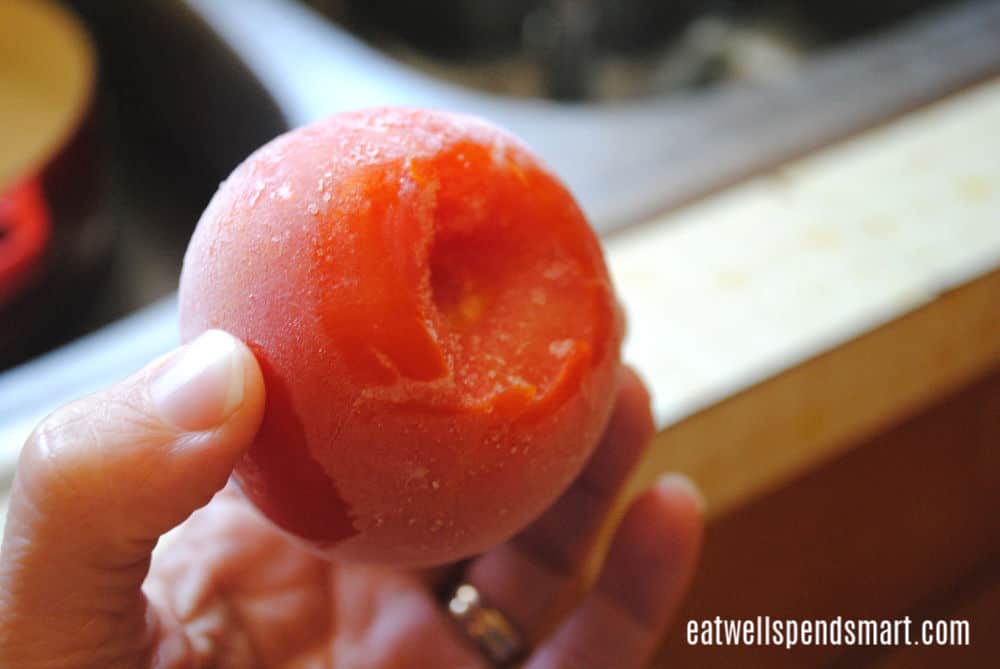 Cut off the top of tomato to freeze whole.