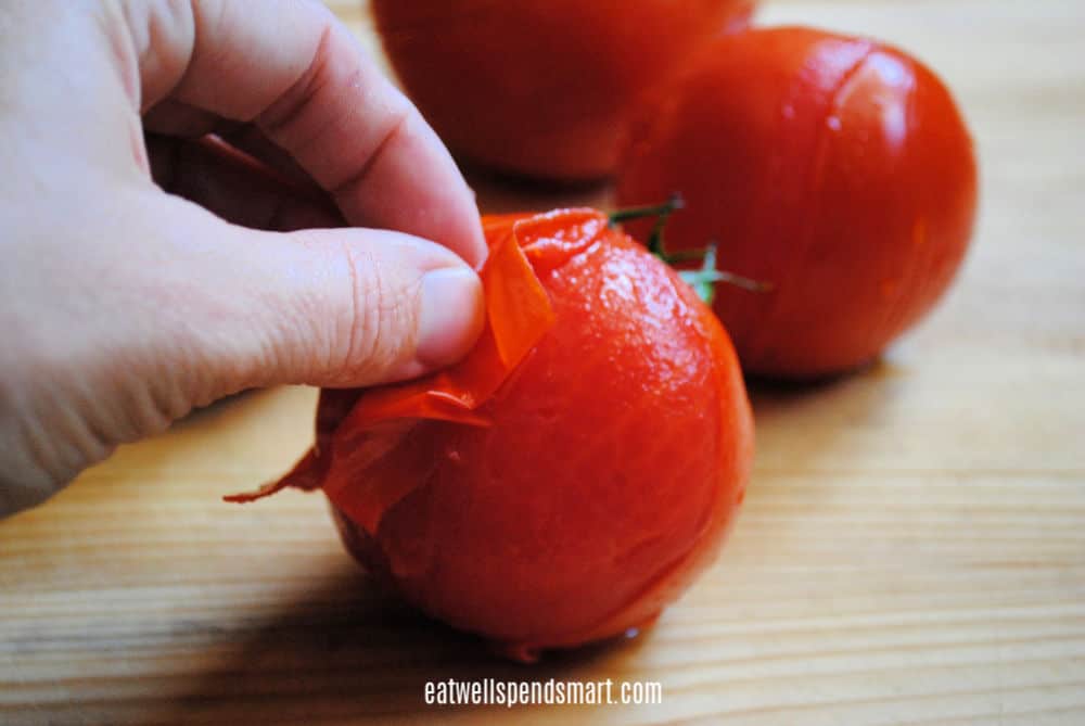 Peeling skin off blanched tomato