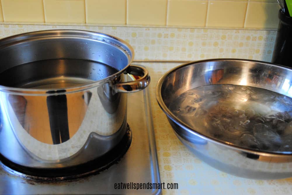 Tools for freezing tomatoes: a large pot and a bowl of ice water