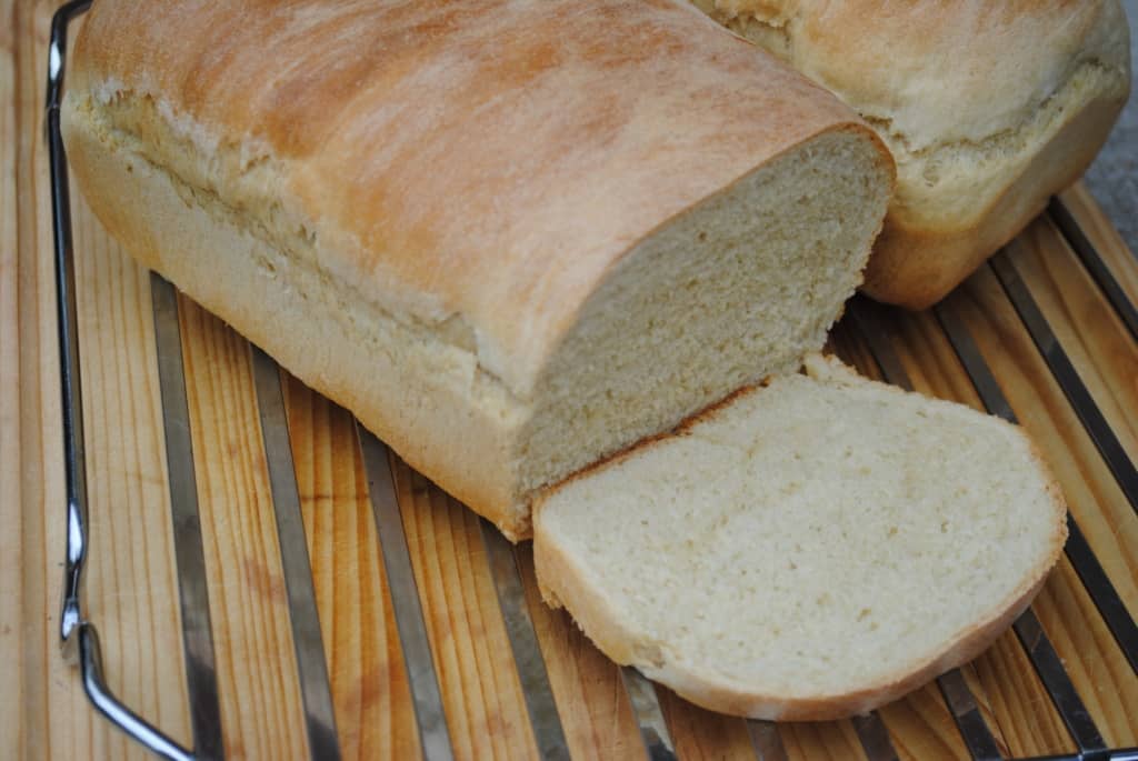 Two loaves of soft homemade bread on a rack