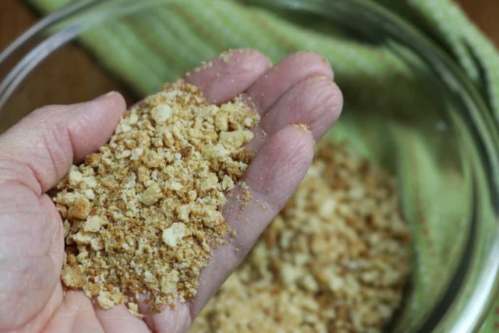 Homemade breadcrumbs in the palm of a hand.