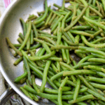 Cooked frozen green beans in a skillet