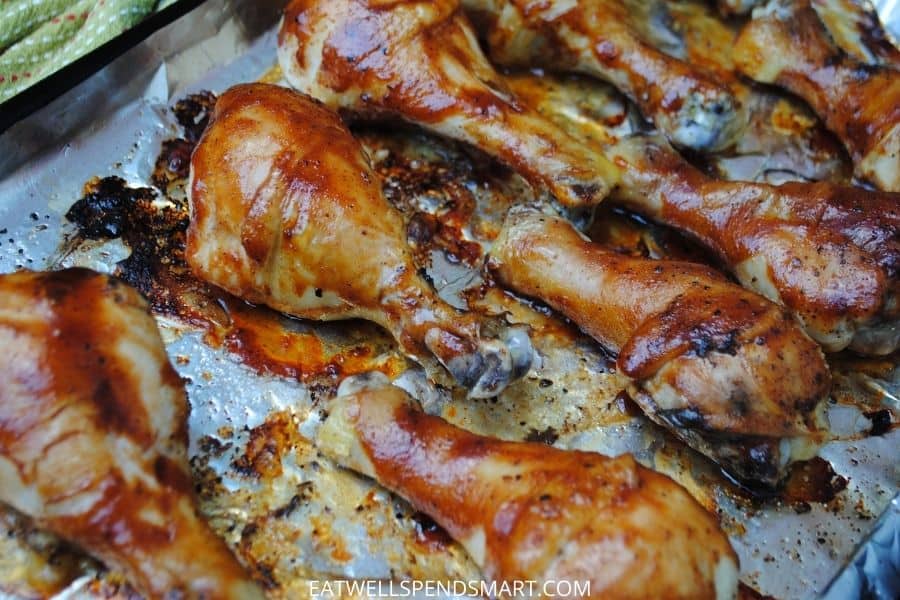 Baked bbq chicken legs on baking sheet