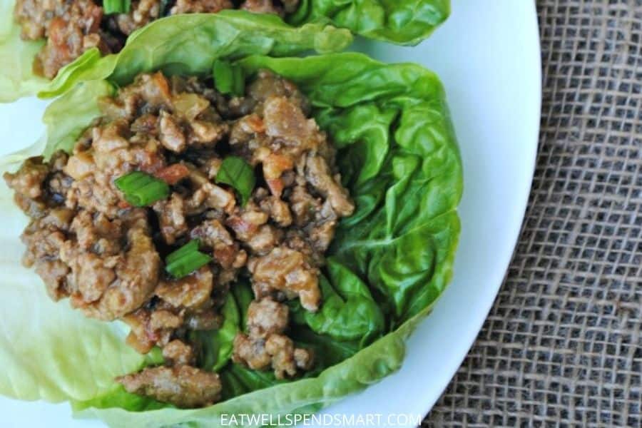 Chicken lettuce wrap on a white plate