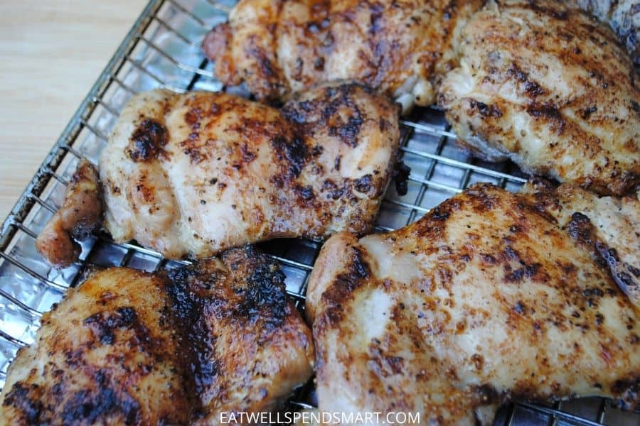 Grilled chicken thighs on a rack