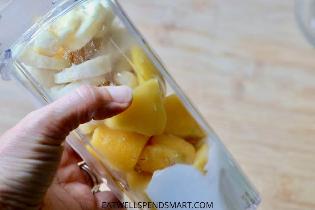 mango chunks, sliced banana, and Greek yogurt in a blender cup