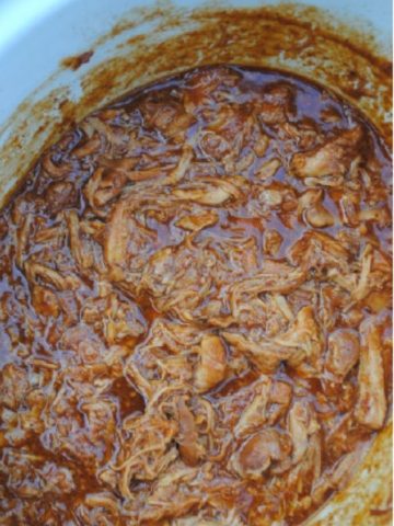 shredded bbq chicken thighs in a slow cooker