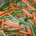 roasted carrots and green beans on a baking sheet