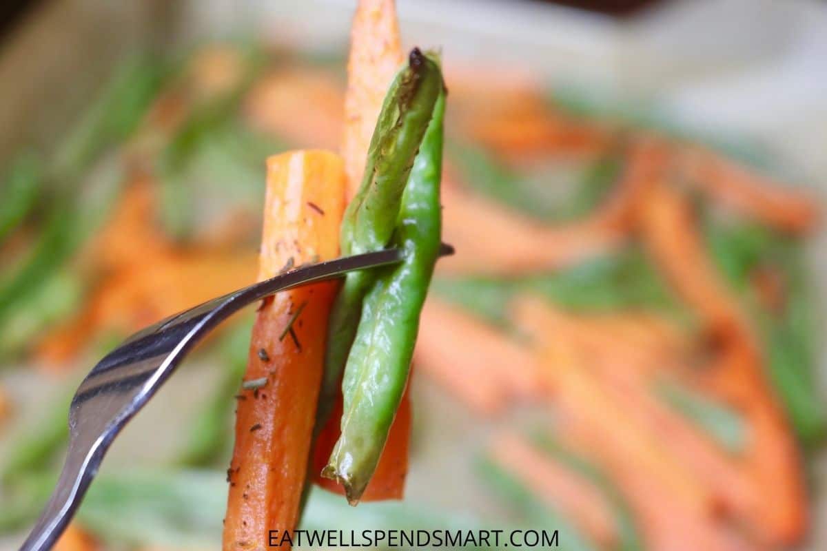 roasted carrots and green beans on a fork