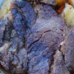 Seared roast surrounded by potatoes and carrots