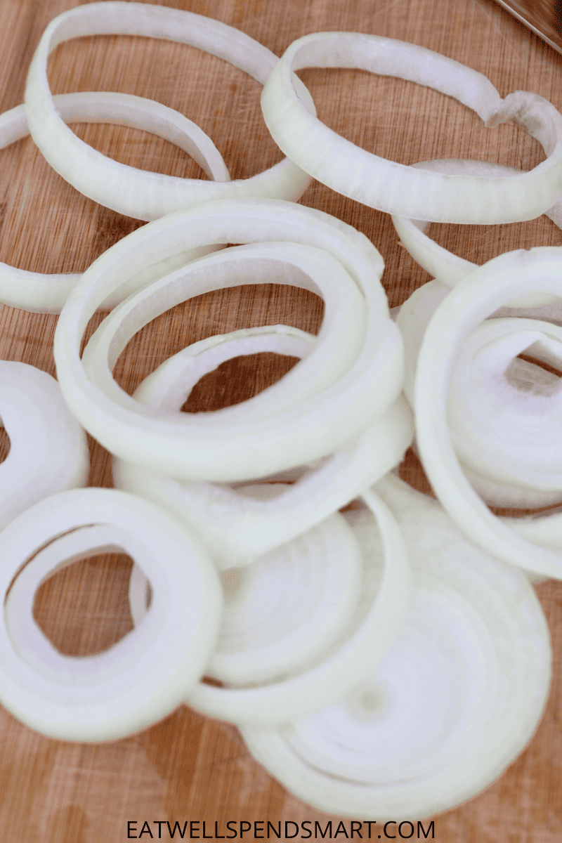onion ring slices on a wooden cutting board