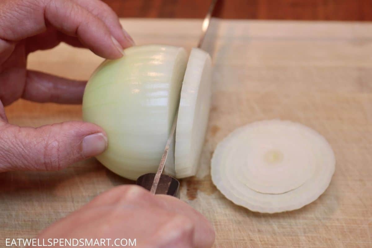 knife slicing onion into rings