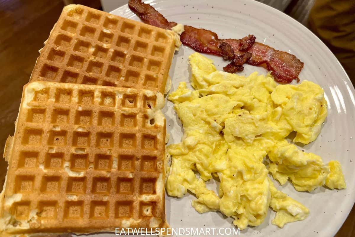 2 waffles, scrambled eggs, and one slice of bacon