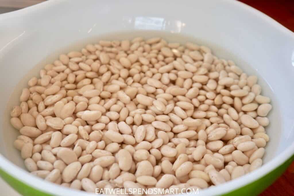 Great northern beans soaking in a bowl filled with water